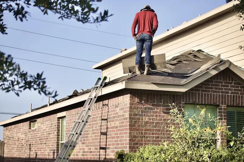 Professional roofer working on a residential roof in Cutchogue Station